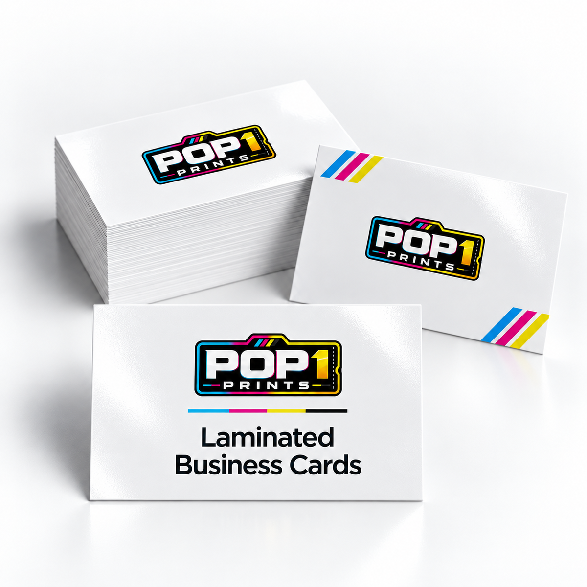 White laminated business cards with POP 1 Prints branding, displayed in stacks with cyan, magenta and yellow corner stripes.