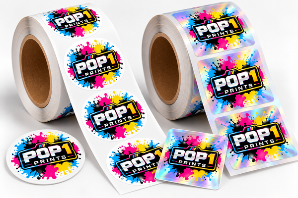 Two rolls of custom POP 1 Prints logo stickers with cyan, magenta and yellow splashes on white labels.